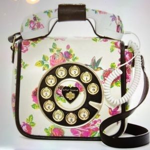 White floral telephone crossbody bag.  Textured leather feel with hot pink roses